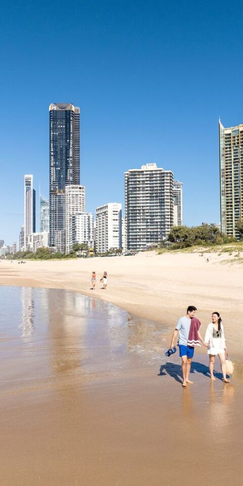 People walking along beach at the gold coast - credit to tourism australia